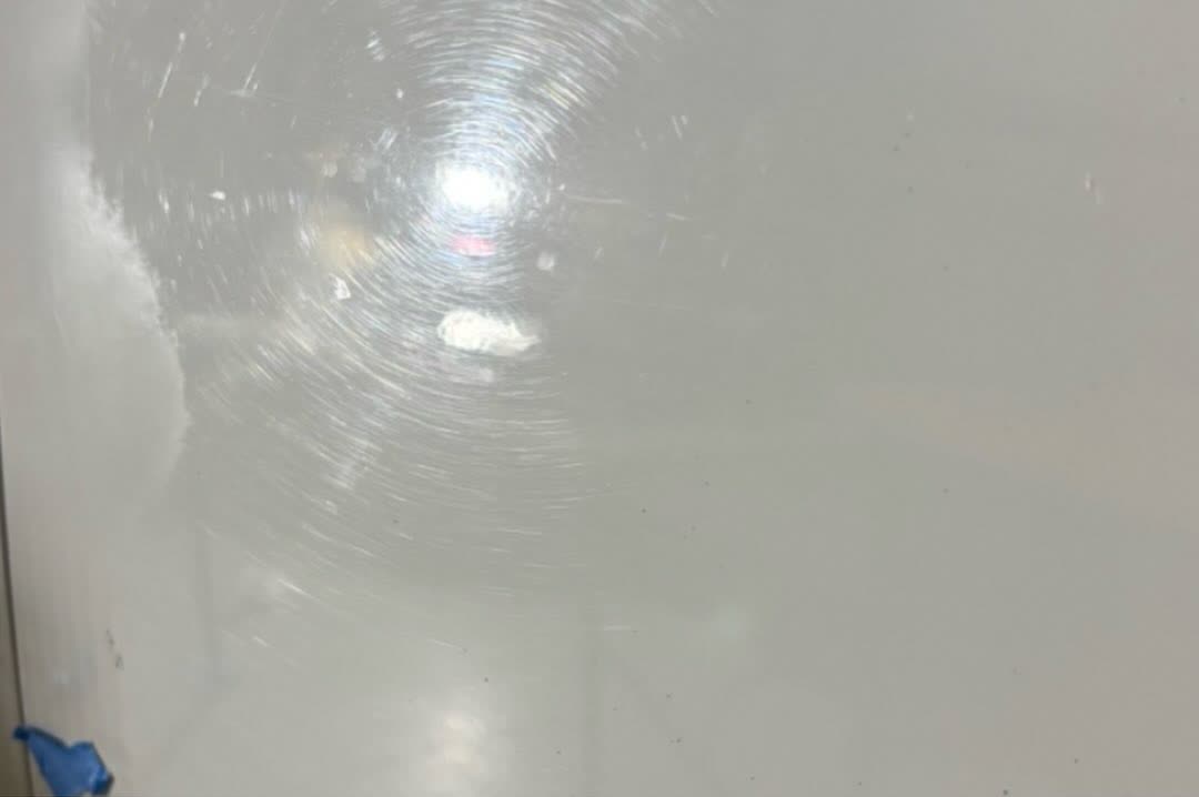 White truck panel with swirl marks before correction