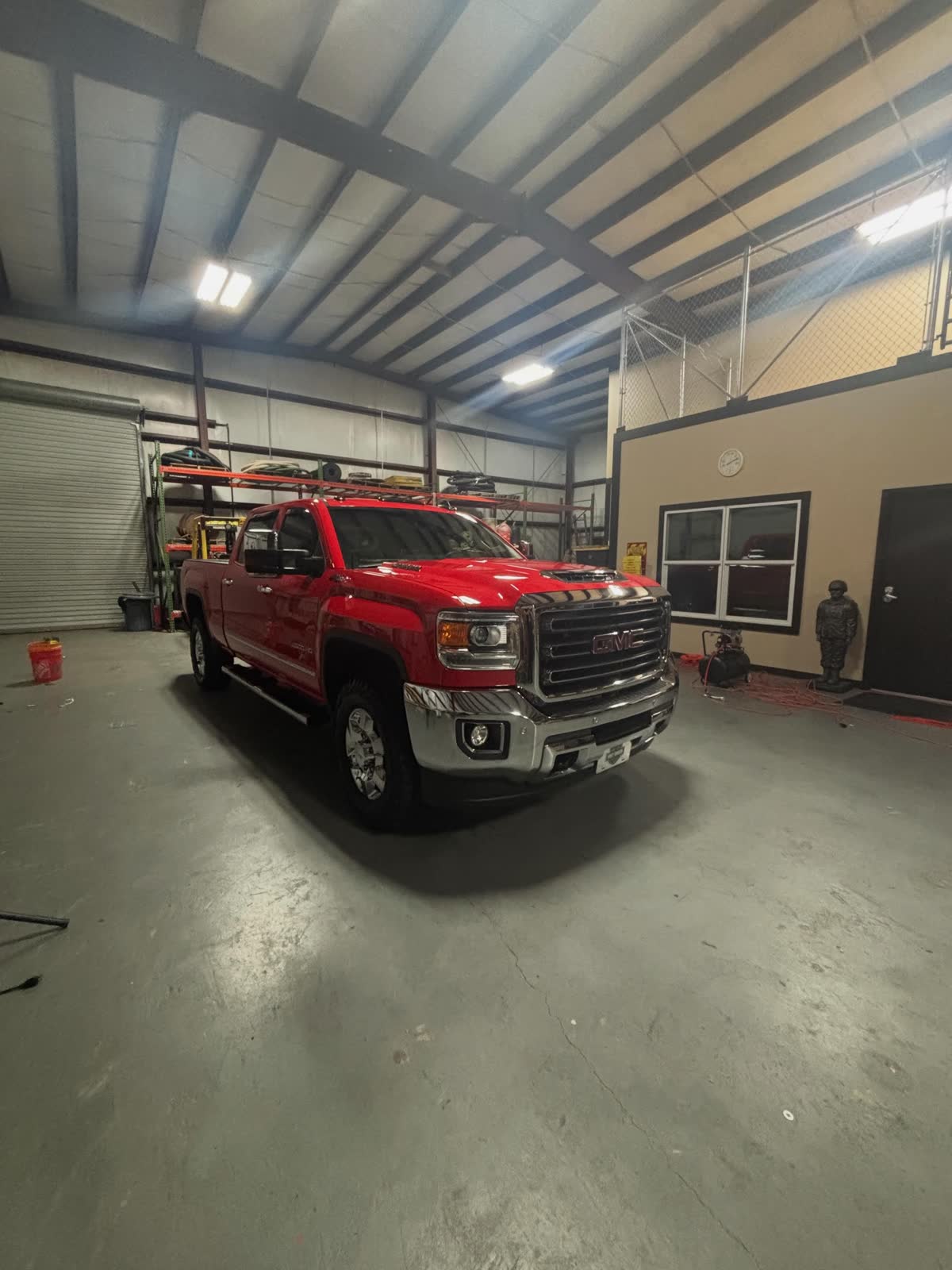 Red GMC Sierra parked inside the Lacoste warehouse